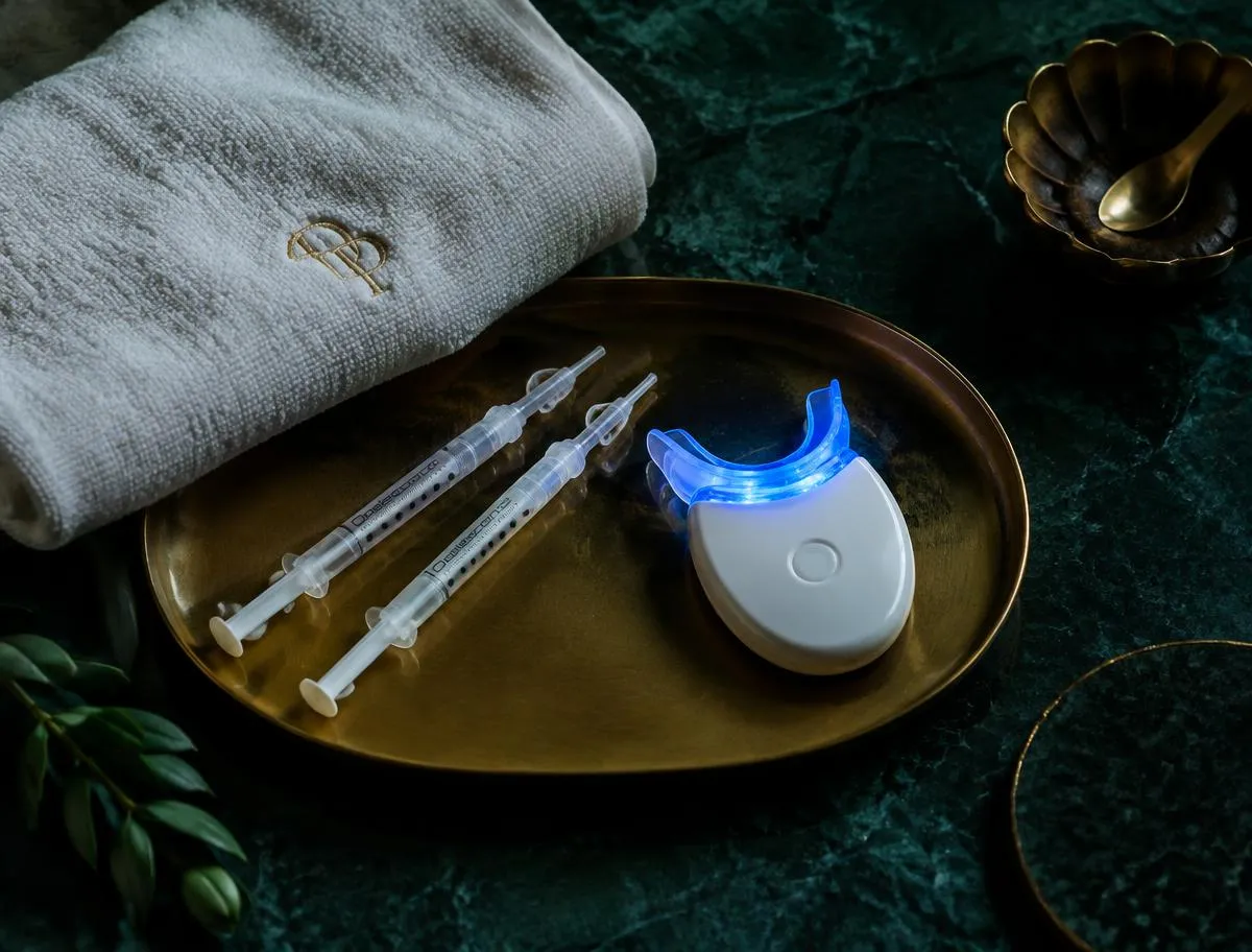 Blue LED teeth whitening device and gel on a brass tray